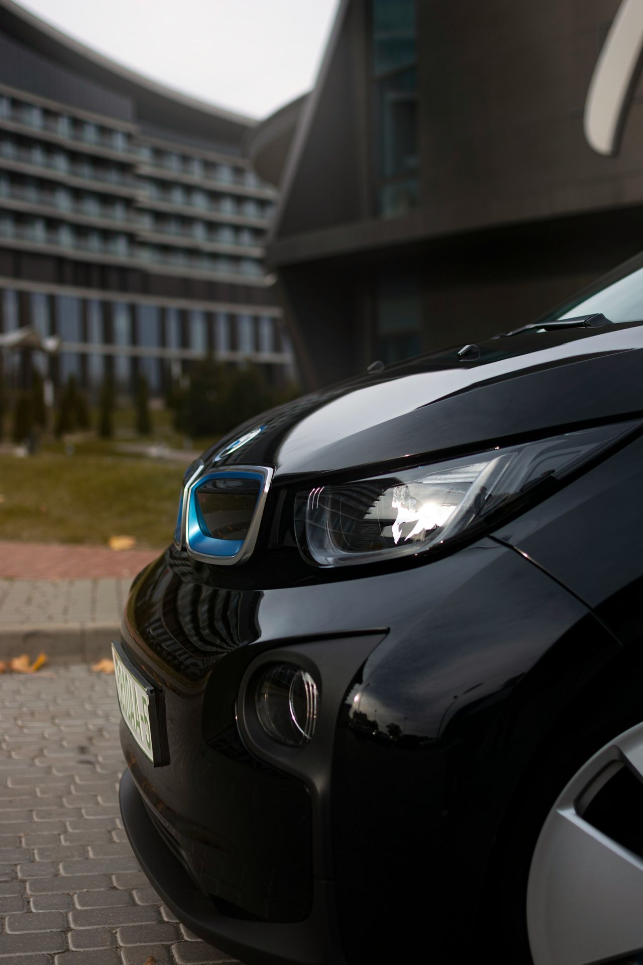 a black car parked on a brick road